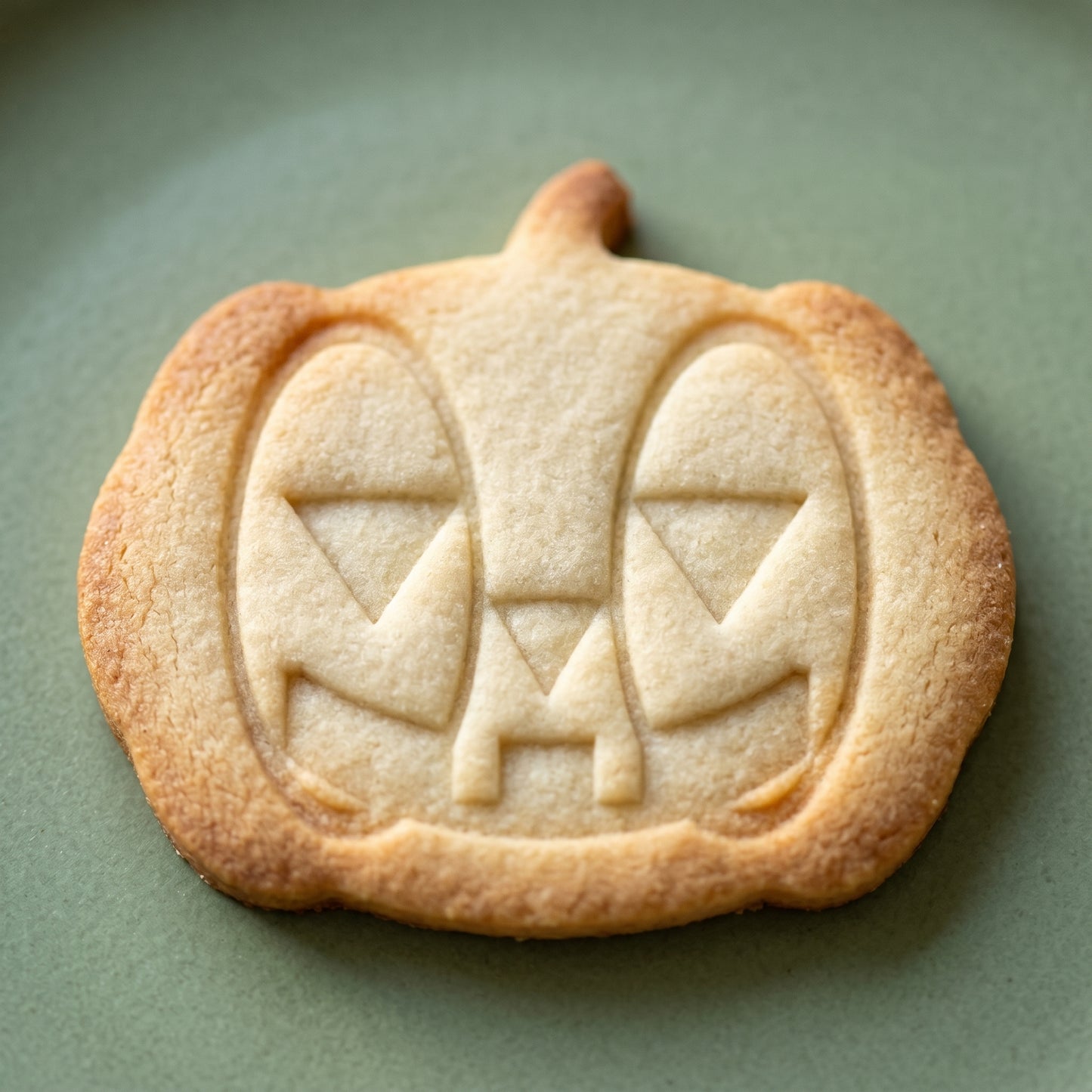 Pumpkin jack-o-lantern shaped sugar cookie
